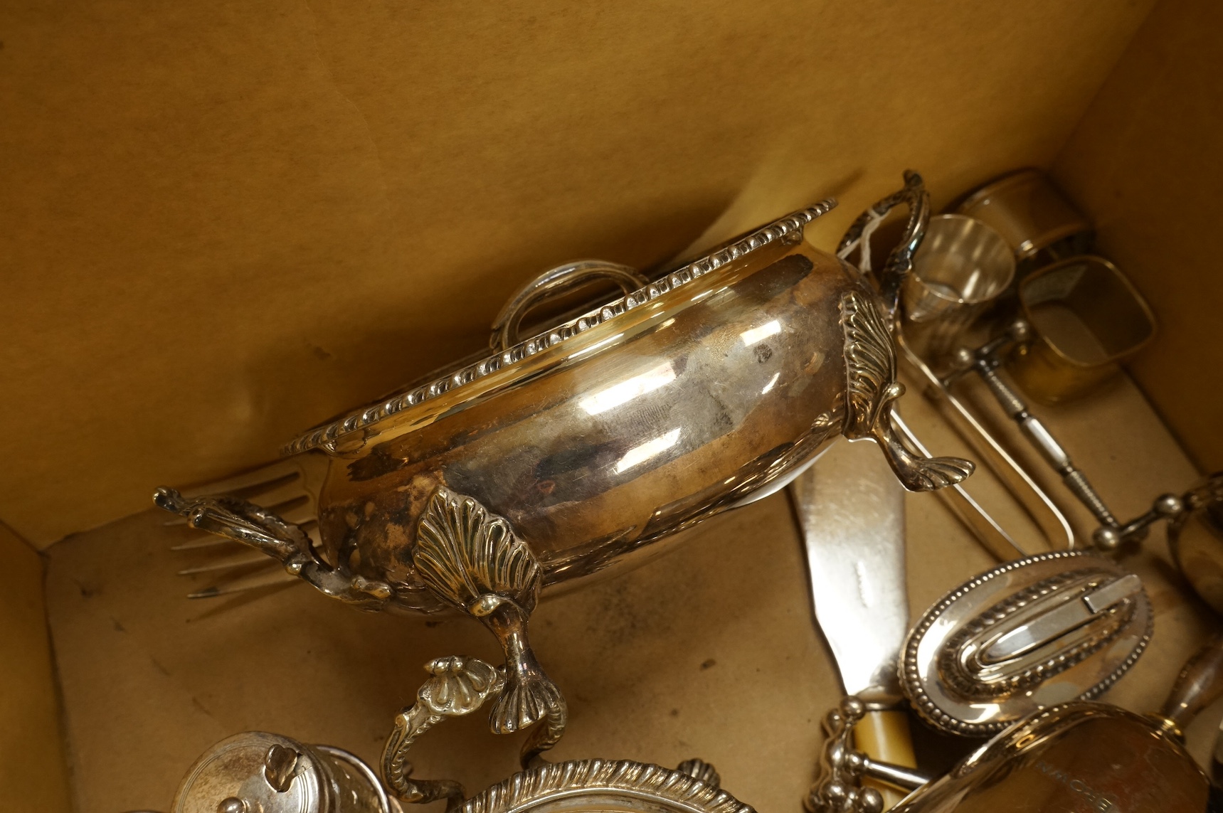 A small collection of silver plated ware to include a trophy, napkin rings and a pair of small tureens. Condition - fair